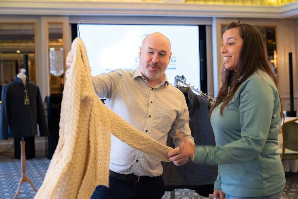 Dominic O'Sullivan presenting a wool cardigan gift option to a client