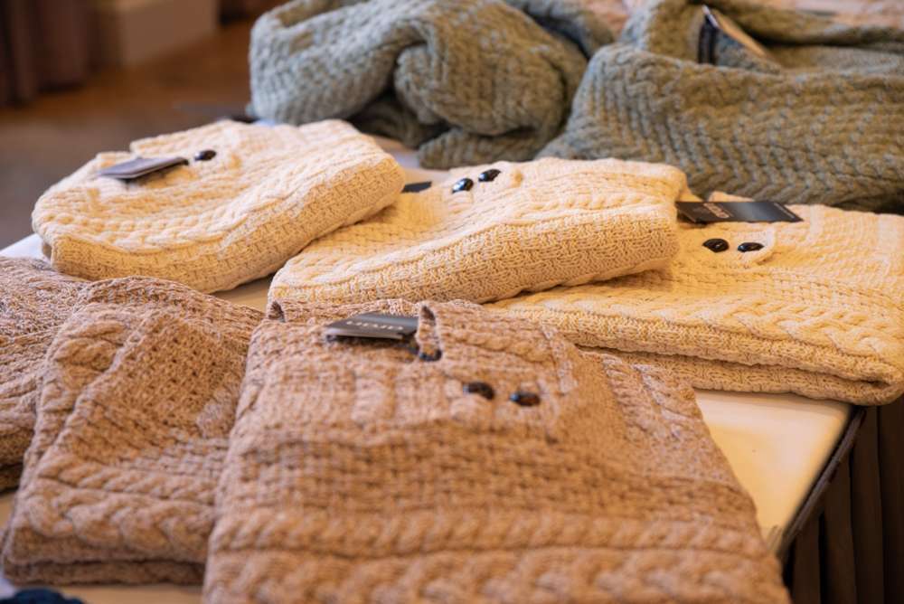 Close-up of ladies’ Irish wool ponchos on display at a corporate gifting event