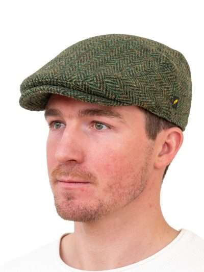 The Dubliner tweed cap made from 100% Donegal Tweed with curved peak, quilted lining, and back strap