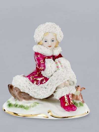 Irish Dresden Lara Winter maroon porcelain figurine sitting on a sleigh by A. Dutz